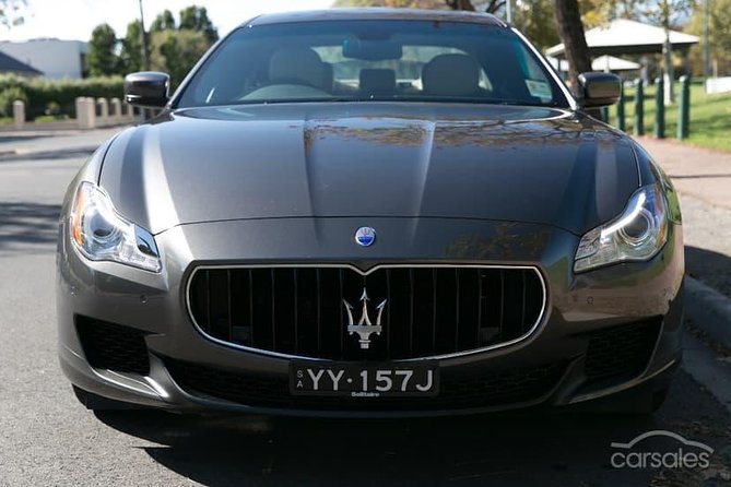 Maserati Quattroporte Limousine Transfer Cairns Airport to City - Personalized Assistance and Escort Service