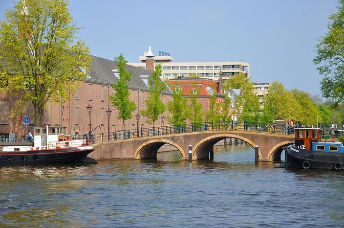 Amsterdam Canals Boat Tour With Audio Guide - Key Points