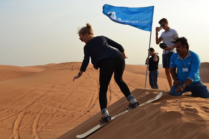 Enjoy the Dubai Fossil Rocks Desert With Sandboarding, Camel Ride,& BBQ Dinner - Sandboarding Thrills in the Desert