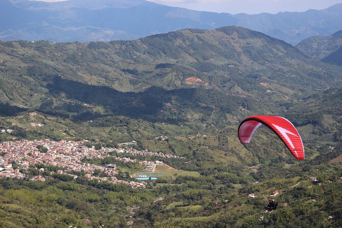 Paragliding Flight Over a Valley of Mountains and Waterfalls Video - Pricing Details