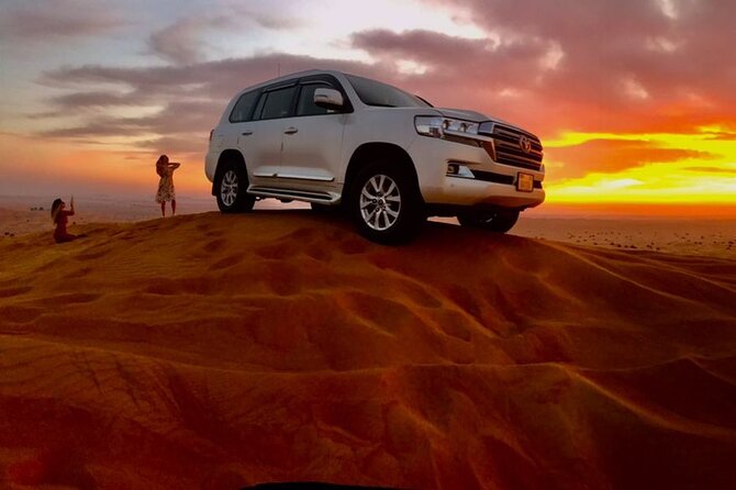 Dubai Dune Bashing With Camel Ride, Sandboarding & BBQ Dinner - Try Sandboarding on Desert Dunes