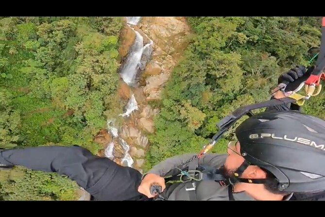 Paragliding Flight Over a Valley of Mountains and Waterfalls Video - Scenic Views