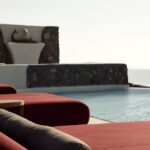 daybed relaxation with infinity pool use with caldera views Daybed Relaxation With Infinity Pool Use With Caldera Views