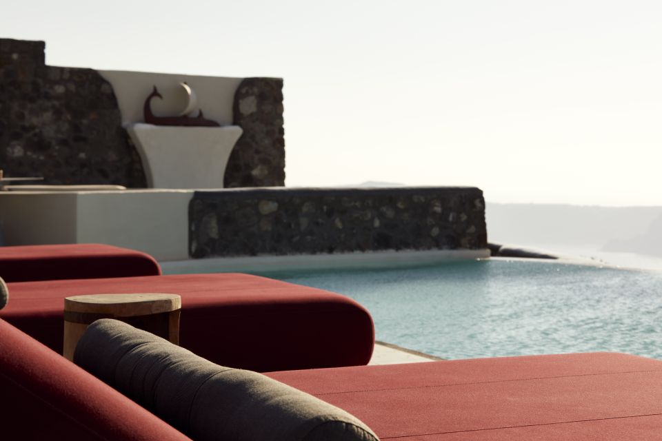 daybed relaxation with infinity pool use with caldera views Daybed Relaxation With Infinity Pool Use With Caldera Views